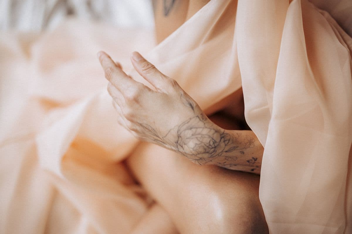 Fine line peony on the back of a hand