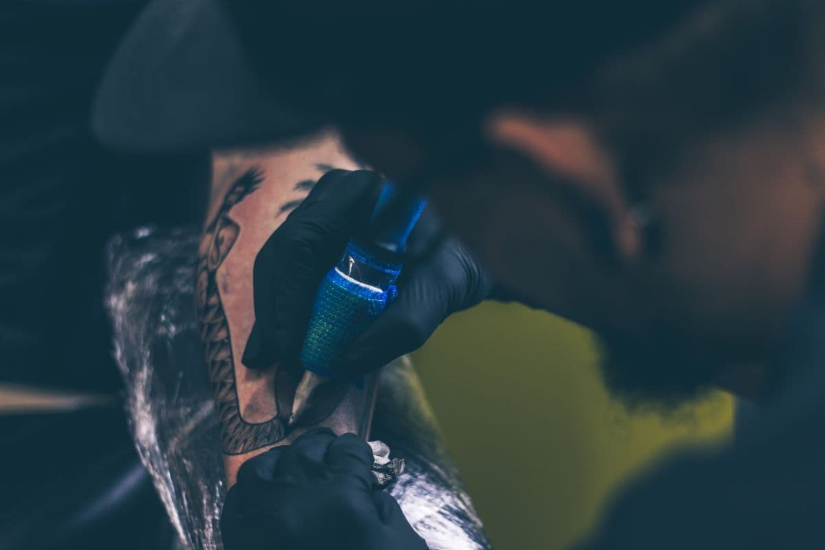An arm piece mid-session, gloved hands and a blue-wrapped grip